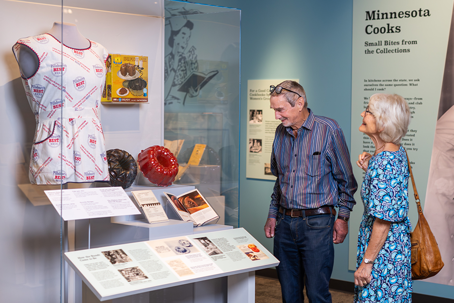 Two visitors at the Minnesota Cooks section of the Julia Child Exhibit.